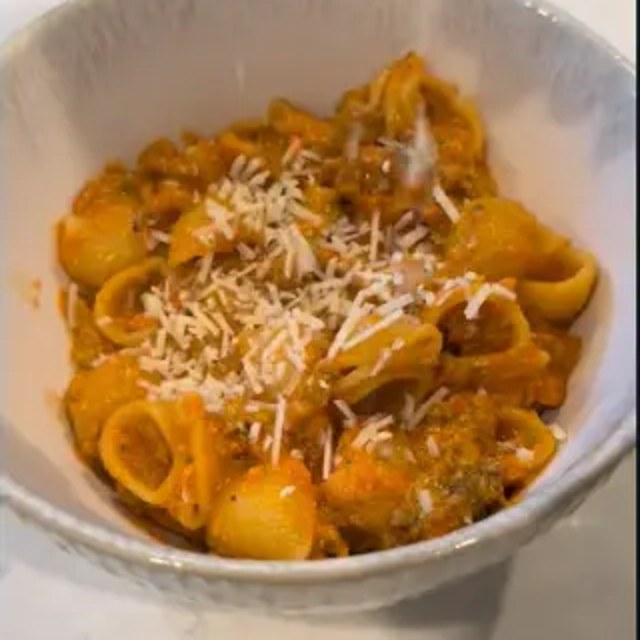Creamy pasta dinner topped with parmesan